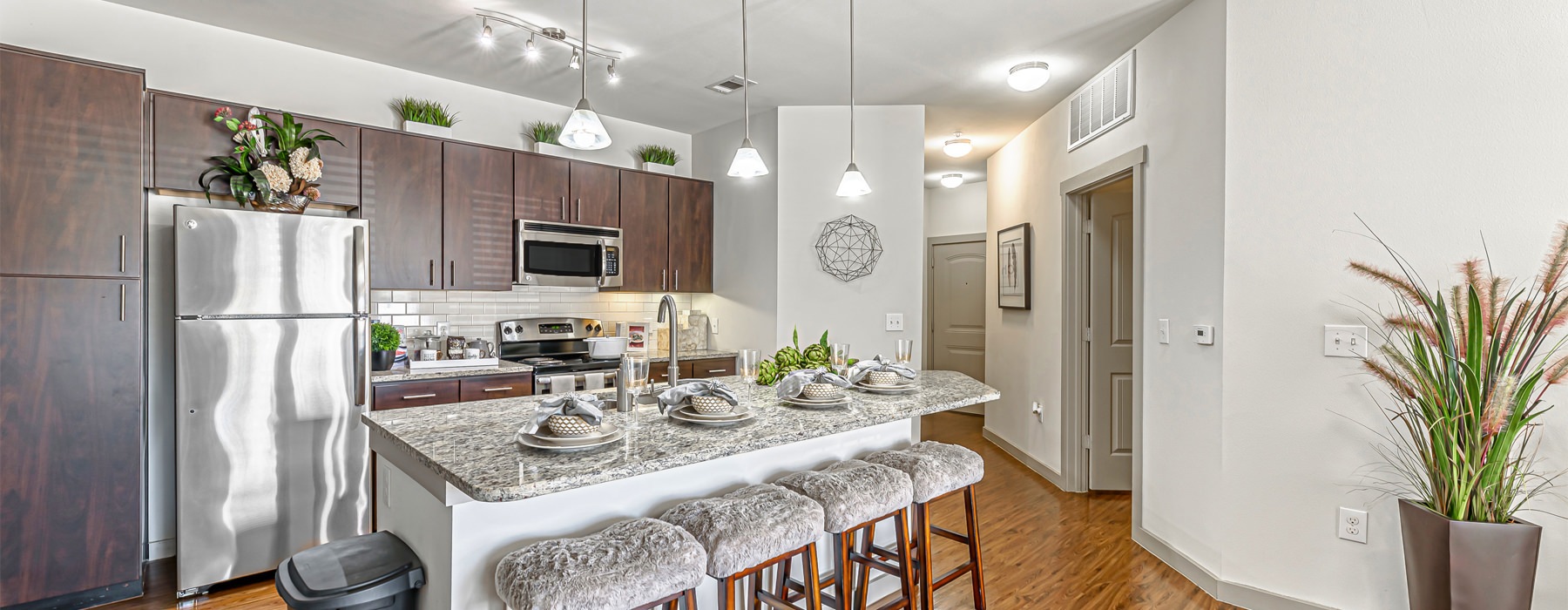 A modern kitchen with granite countertops and stainless steel appliances