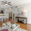 Bright living room with wood floors and modern kitchen