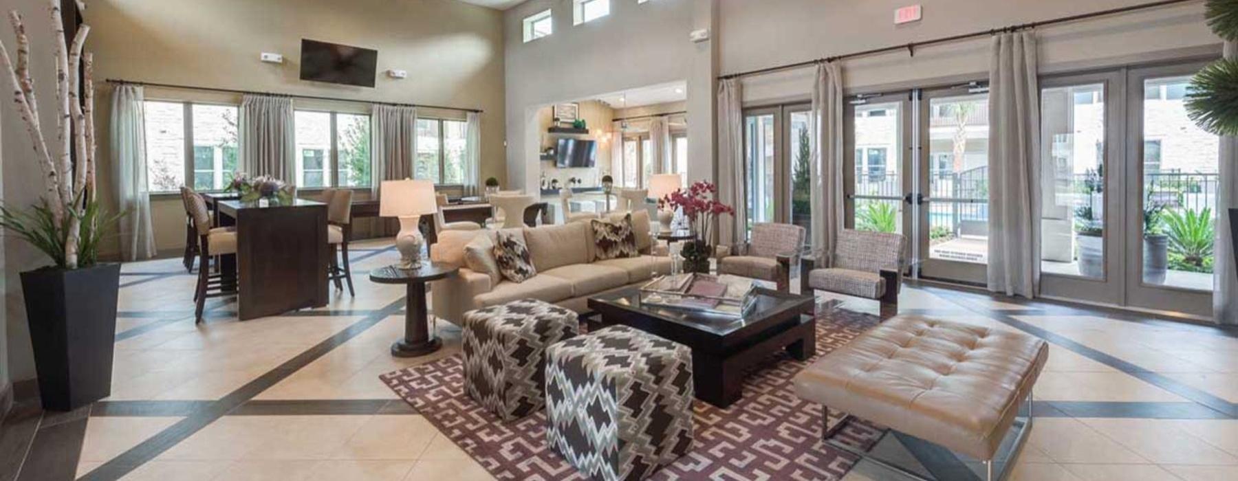 a large living room with a large chandelier and a large rug