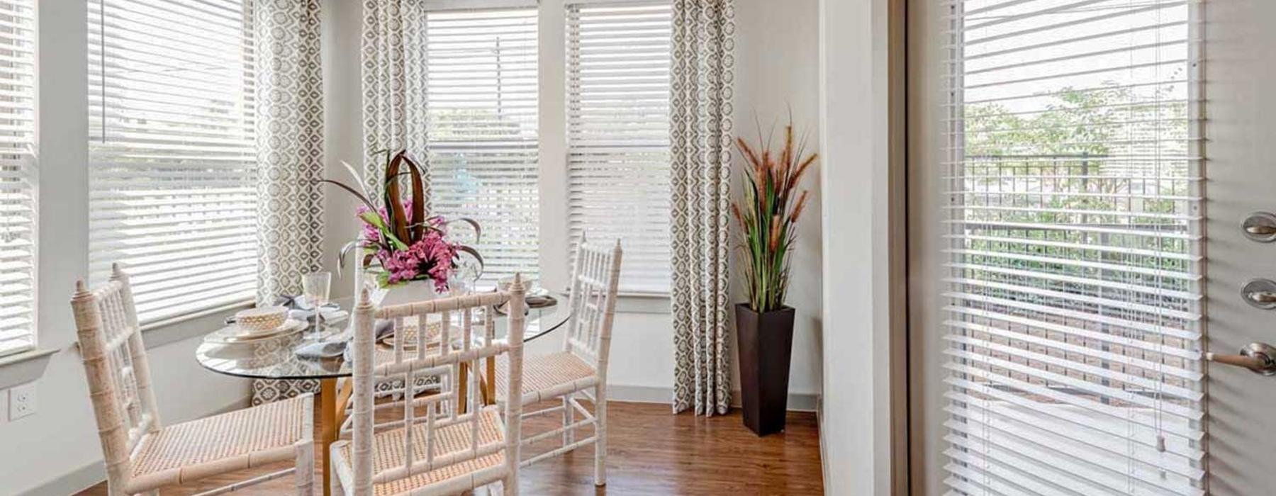 a dining room with a table and chairs