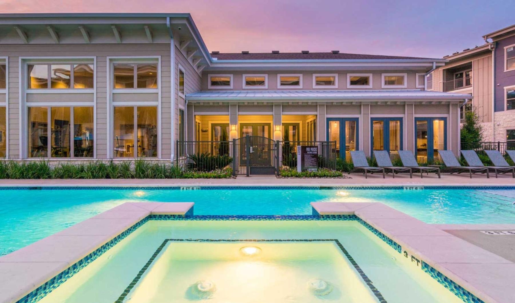 a swimming pool in front of a house